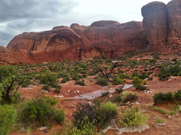 You can see an arch forming out of that rock. The rain reveals that it is actually separating from the rock.